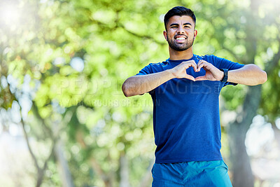 Buy stock photo Runner man, smile and heart hands in portrait for wellness, strong body or fitness by trees in park. Outdoor training, nature workout or running exercise or young guy for happiness, love or self care