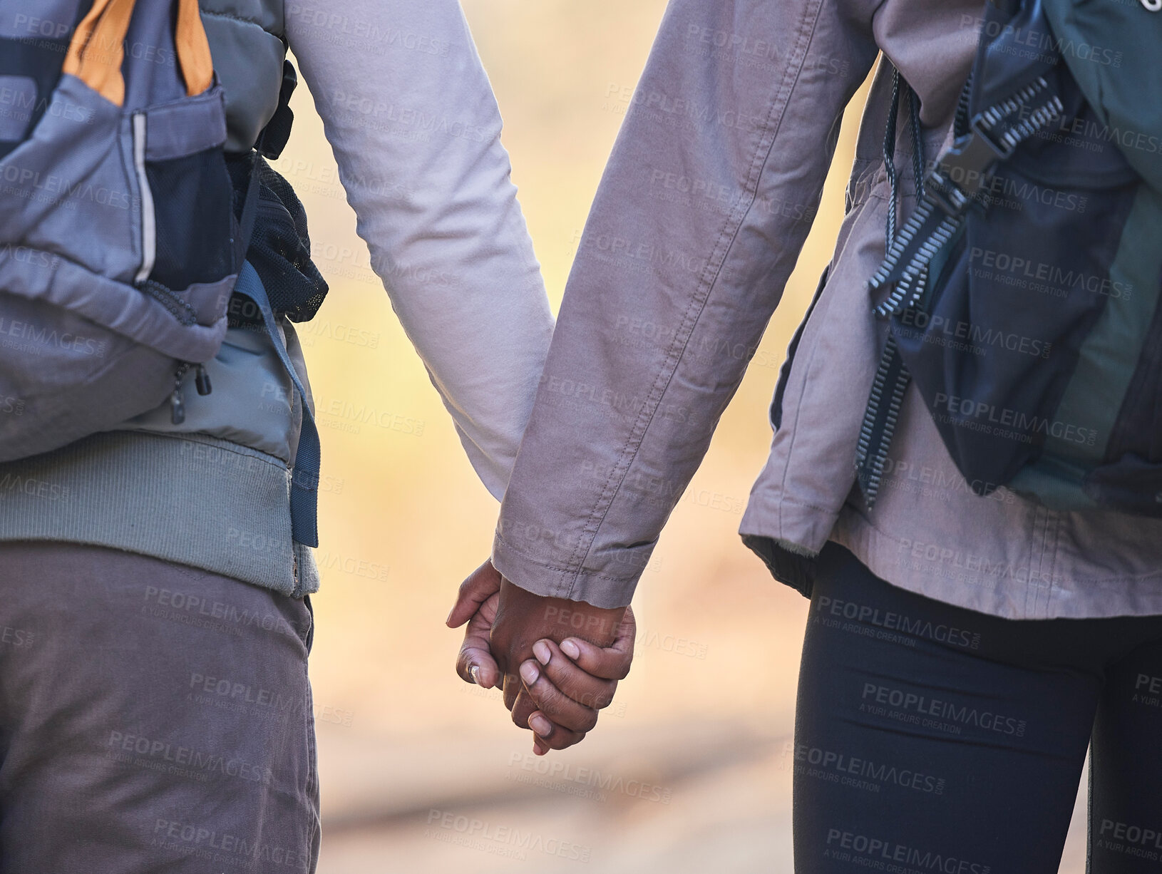 Buy stock photo Holding hands, couple outdoor hiking with support and trust, fitness and adventure with commitment. Travel, exercise and people together in nature, health and wellness with partnership back view