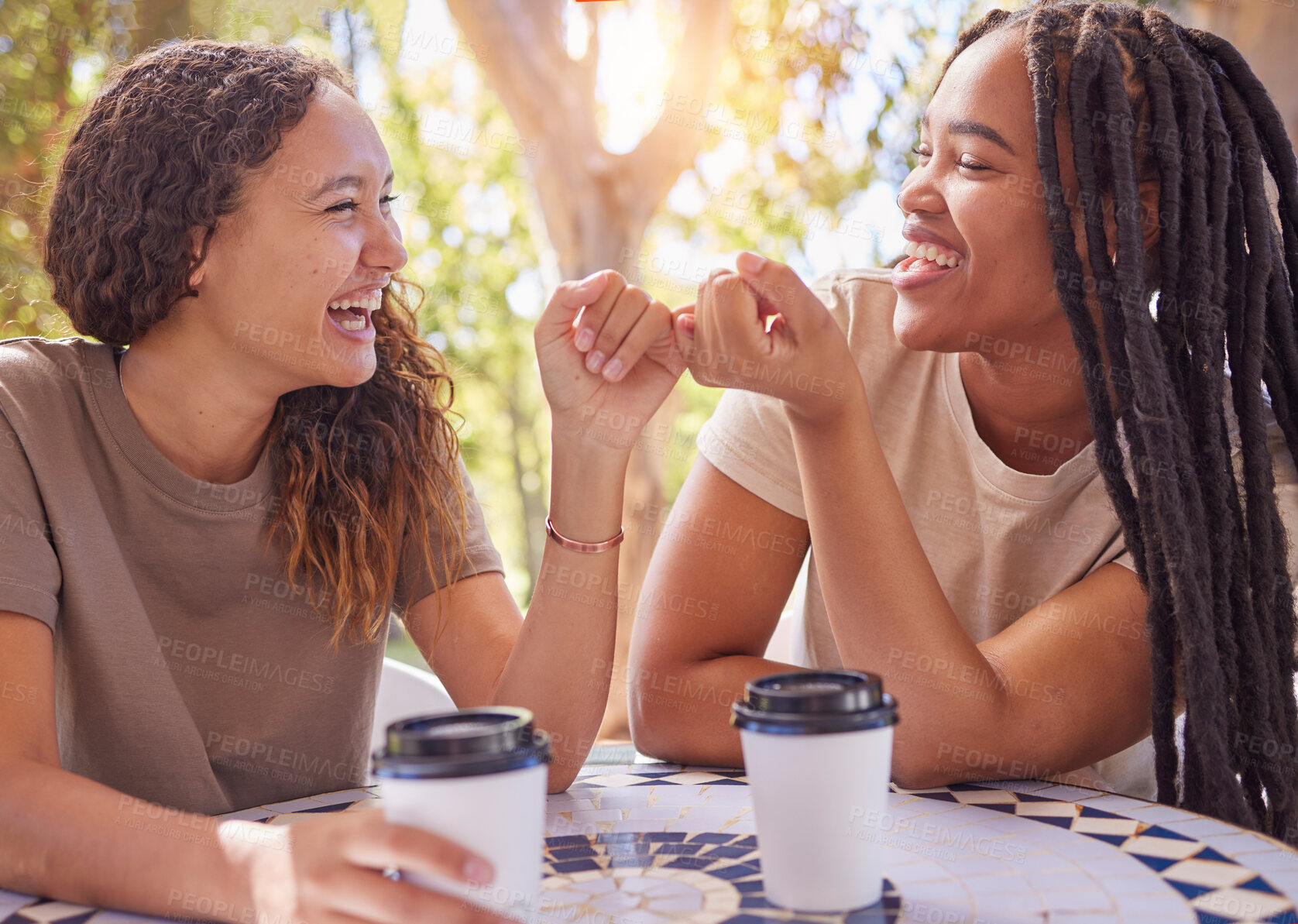 Buy stock photo Happy, pinky promise and women friends in nature enjoying coffee, talking and bonding together. Happiness, secret and young female best friends speaking and drinking tea in an outdoor garden or park.