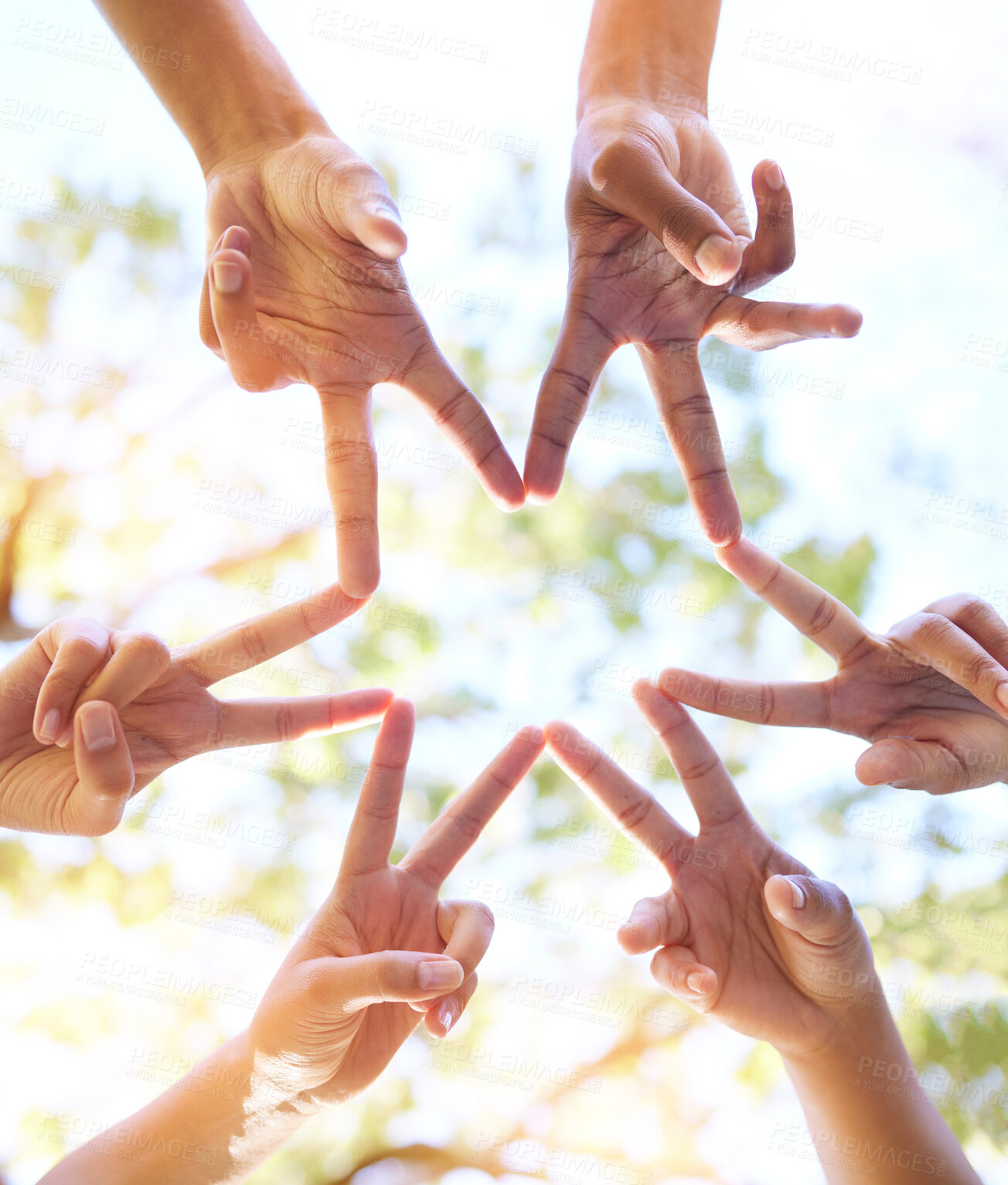 Buy stock photo Hands together, star sign and team sun gesture with hand to show group work and community. Outdoor, lens flare and below of people doing teamwork with friends showing commitment and solidarity 