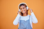 Wall, mockup and woman with headphones, music and relax with confident girl on studio background. Young female, lady and headset for podcast, radio and audio with sounds, streaming and listen to song