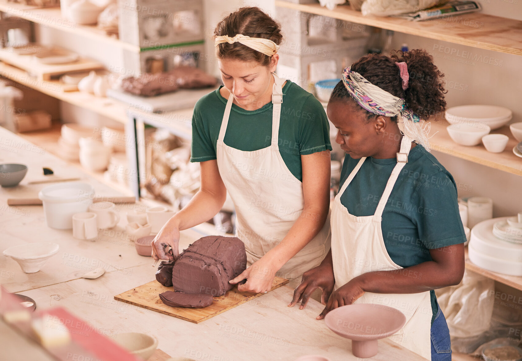 Buy stock photo Art business and team training with clay for sculpting preparation process and productivity in creative workshop. Focus, concentration and interracial colleagues dividing product in pottery workspace