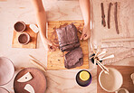 Pottery woman and hands with clay top view at table with tools for production and manufacturing. Sculptor process and handmade ceramic workshop of small business owner and artist dividing product.