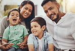 Father, mother and children with smile for family time, holiday break or weekend relaxing on living room sofa at home. Happy dad, mom and kids smiling in joy for fun bonding or relationship indoors