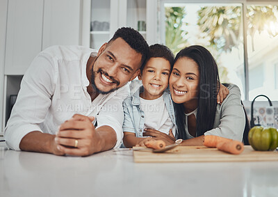 Buy stock photo Kitchen, portrait and parents with their boy child to cook dinner, supper or lunch together. Love, smile and happy family from Brazil preparing healthy food or meal with vegetables in their house.
