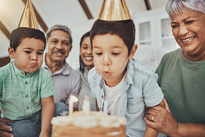 Buy stock photo Kids, birthday cake and kid blowing candles at a house at a party with food and celebration. Children, celebrate event and family together in a kitchen with a smile and happiness with parent love