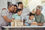 Birthday, celebration and twin children with family blowing the candles on a cake at their party. Happy, excited and kids with their parents and grandparents in the kitchen of their home to celebrate