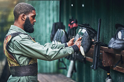 Buy stock photo Paintball man, prepare safety mask and clothes with gear, camouflage and start for outdoor combat game. African guy, war games or adventure for training, shooting or training for tactical development