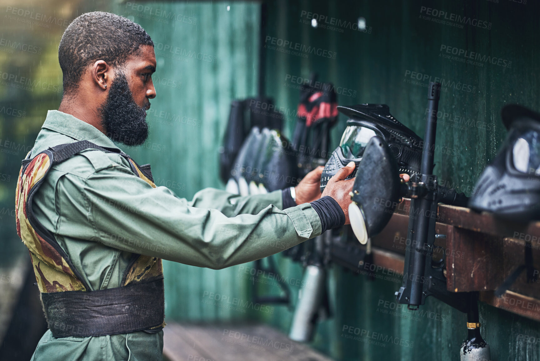 Buy stock photo Paintball man, prepare safety mask and clothes with gear, camouflage and start for outdoor combat game. African guy, war games or adventure for training, shooting or training for tactical development