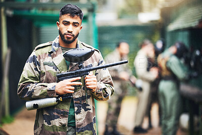 Buy stock photo Paintball game and portrait of a man with gun and safety uniform for outdoor shooting battle. Assertive and young indian guy in camouflage clothing ready for shooter sport and activity.

