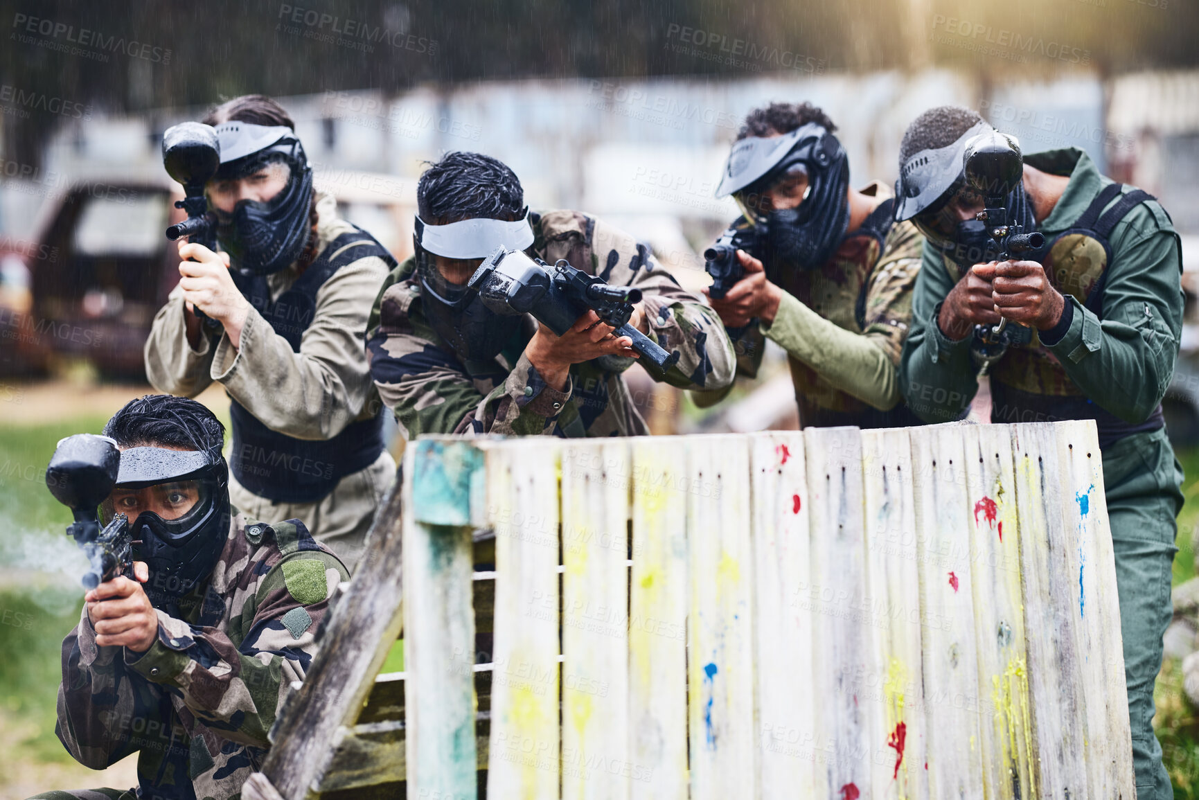 Buy stock photo Paintball, gun or team play in a shooting game together on a fun battlefield on holiday. Men on a mission, fitness or players aim with military weapons gear for survival in an outdoor competition