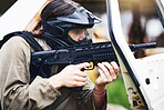 Paintball, gun or woman in a shooting game playing with fast action on fun battlefield on holiday. Military mission, target aim or player with weapons gear for war survival in an outdoor competition