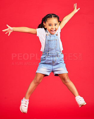 Buy stock photo Excited, playful and portrait of a girl jumping while isolated on a red background in a studio. Youth, smile and child with freedom, energy and happiness while playing with a jump on a backdrop