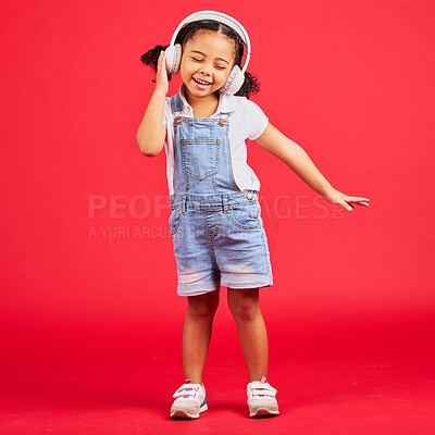 Buy stock photo Dancing, energy or little girl on music headphones, fun radio or childrem podcast on isolated red background. Smile, happy or dancer kid listening to audio, sound and streaming media on studio mockup