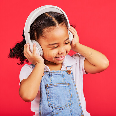 Buy stock photo Happy, child and headphones for music, radio and fun podcast on isolated red background and dancing studio. Smile, little girl and kid listening to dance audio, song and streaming media on backdrop