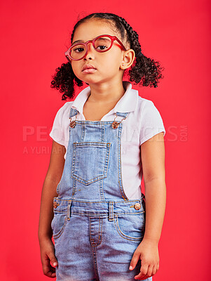 Buy stock photo Portrait, glasses and unhappy with a black girl on a red background in studio for vision or eyesight. Kids, sad or bored with a female child wearing a new frame prescription spectacles for correction