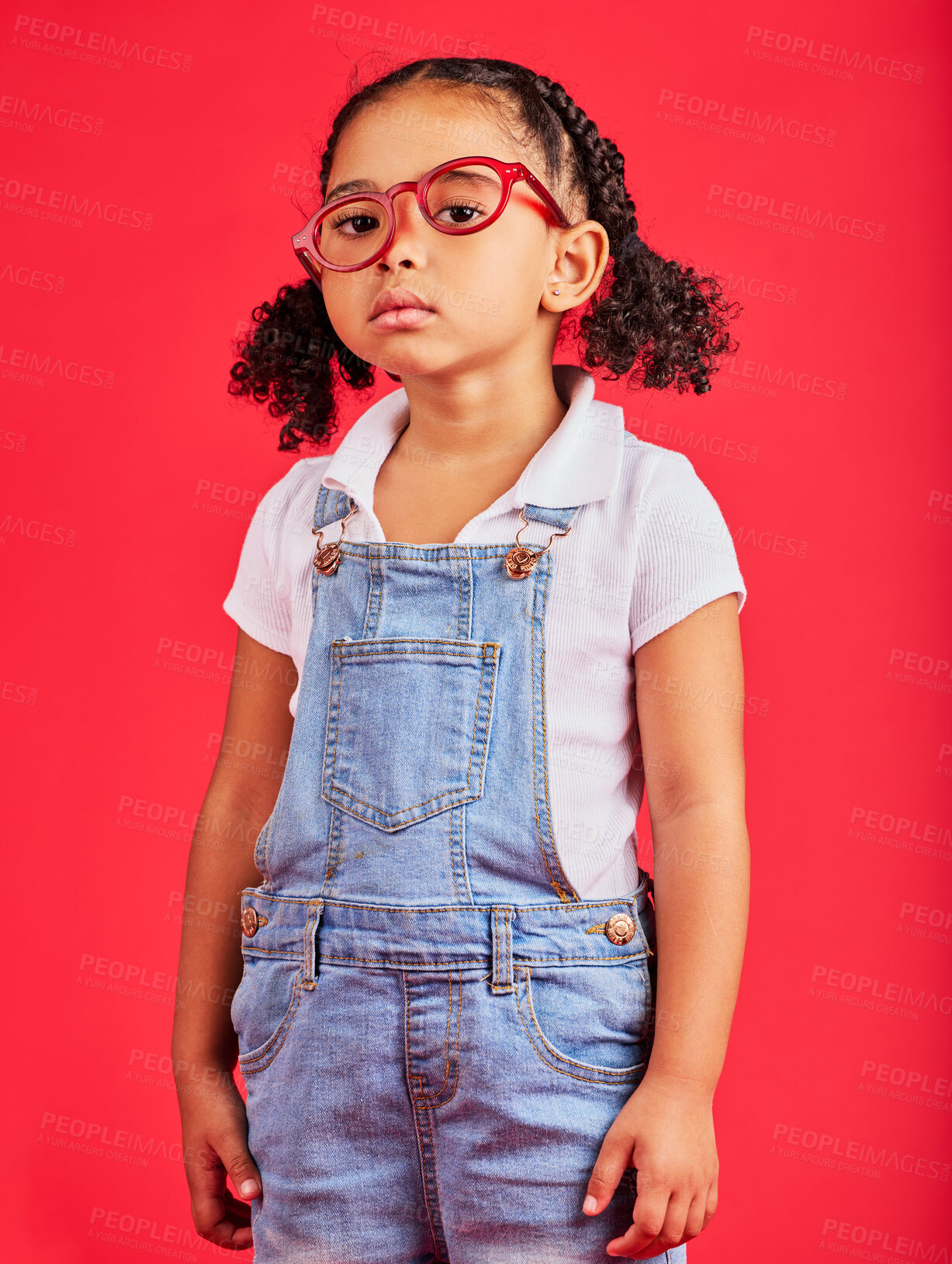 Buy stock photo Portrait, glasses and unhappy with a black girl on a red background in studio for vision or eyesight. Kids, sad or bored with a female child wearing a new frame prescription spectacles for correction