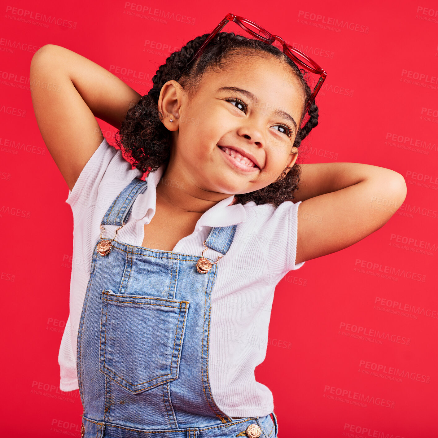 Buy stock photo Little girl, happy and thinking in fashion pose, trendy or cool style clothes on isolated red background for kids branding. Smile, youth and child stretching arms in playful, funny and goofy posing