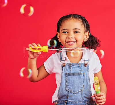 Buy stock photo Little girl, portrait or bubbles playing on isolated red background in hand eye coordination, kids activity or fun game. Smile, happy or child and soap wand, studio toy or breathing development skill
