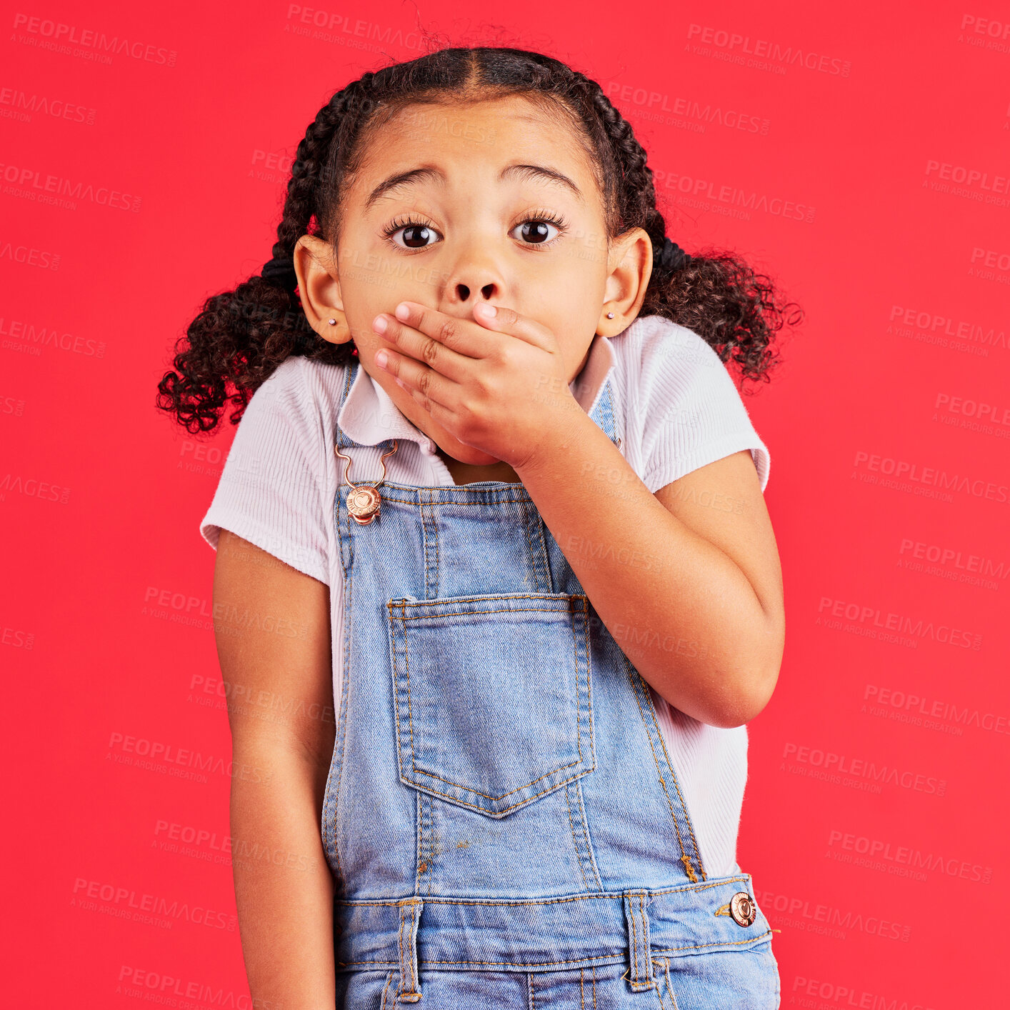 Buy stock photo Shocked child, portrait and hand on mouth in secret, oops and mistake facial expression on isolated red background. Kid, little girl and surprised face in gossip, news or emoji at studio announcement