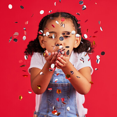 Buy stock photo Young girl, child blowing confetti with party and celebration, silver and glitter isolated against red background. Fun, youth and kid at event, celebrate and birthday in studio with decoration