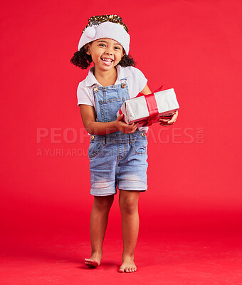 Buy stock photo Portrait, christmas and gift with a black girl on a red background in studio for festive celebration. Box, present and kids with a happy female child celebrating a holiday tradition in december