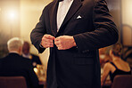 Suit, formal and man tie the button of his jacket at a fancy dinner, party or event banquet. Classy, elegance and male fixing blazer of his elegant outfit at classic supper, celebration or gathering.