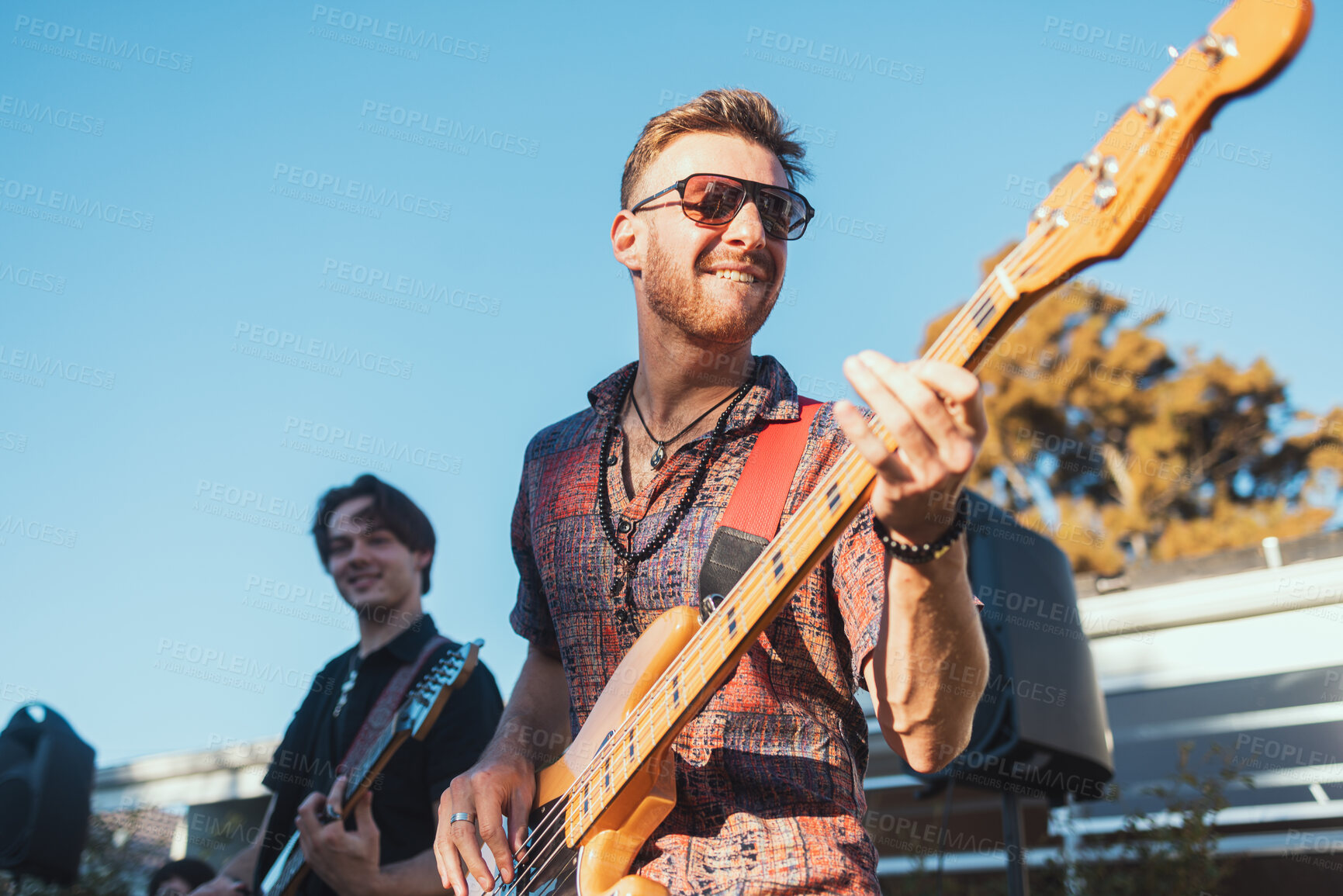 Buy stock photo Guitar, music and party with a band outdoor at a celebration playing a song as a musician or artist. Happy, fun and performance with a man guitarist holding an instrument to perform at a birthday