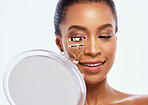 Makeup, beauty and eyelash curler by black woman doing self care or skincare isolated against a studio white background. Happy, cosmetics and face of female model holding product or tool