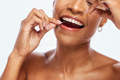 Buy stock photo Tooth, floss and black woman face, flossing for teeth whitening, healthcare and hygiene isolated on white background. Oral care product, dental and mouth cleaning for fresh breath in studio