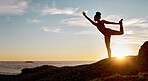 Fitness, woman and yoga stretching in the sunset for spiritual wellness on a rock by the beach in the outdoors. Active female in calm, zen or warm up stretch for healthy exercise, training or workout