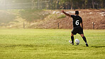 Rugby, player and kick a sports ball on a field during practice, exercise or training outdoors. Athlete, sportsman and man during a game taking a penalty for a championship match on summer day