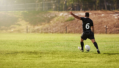 Rugby, player and kick a sports ball on a field during practice, exercise or training outdoors. Athlete, sportsman and man during a game taking a penalty for a championship match on summer day