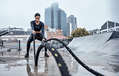 Buy stock photo Fitness, workout and black woman with rope in city for cardio exercise, bodybuilder training and sports. Wellness, motivation and female athlete focus with gear for strong muscles, power and energy