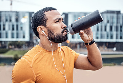 Buy stock photo Fitness, athlete and man drinking water in the city after running for exercise or marathon training. Sports, hydration and male runner enjoying a drink after a intense cardio sport workout in town.