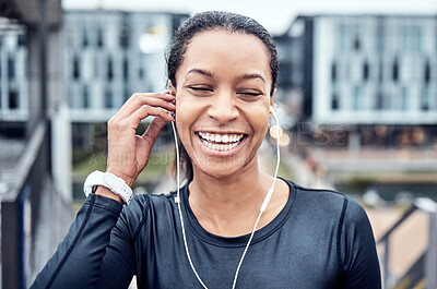 Buy stock photo Music, fitness and face of black woman with smile in city for wellness, healthy body and cardio workout. Sports, headphones and girl listening to audio for exercise, running and marathon training