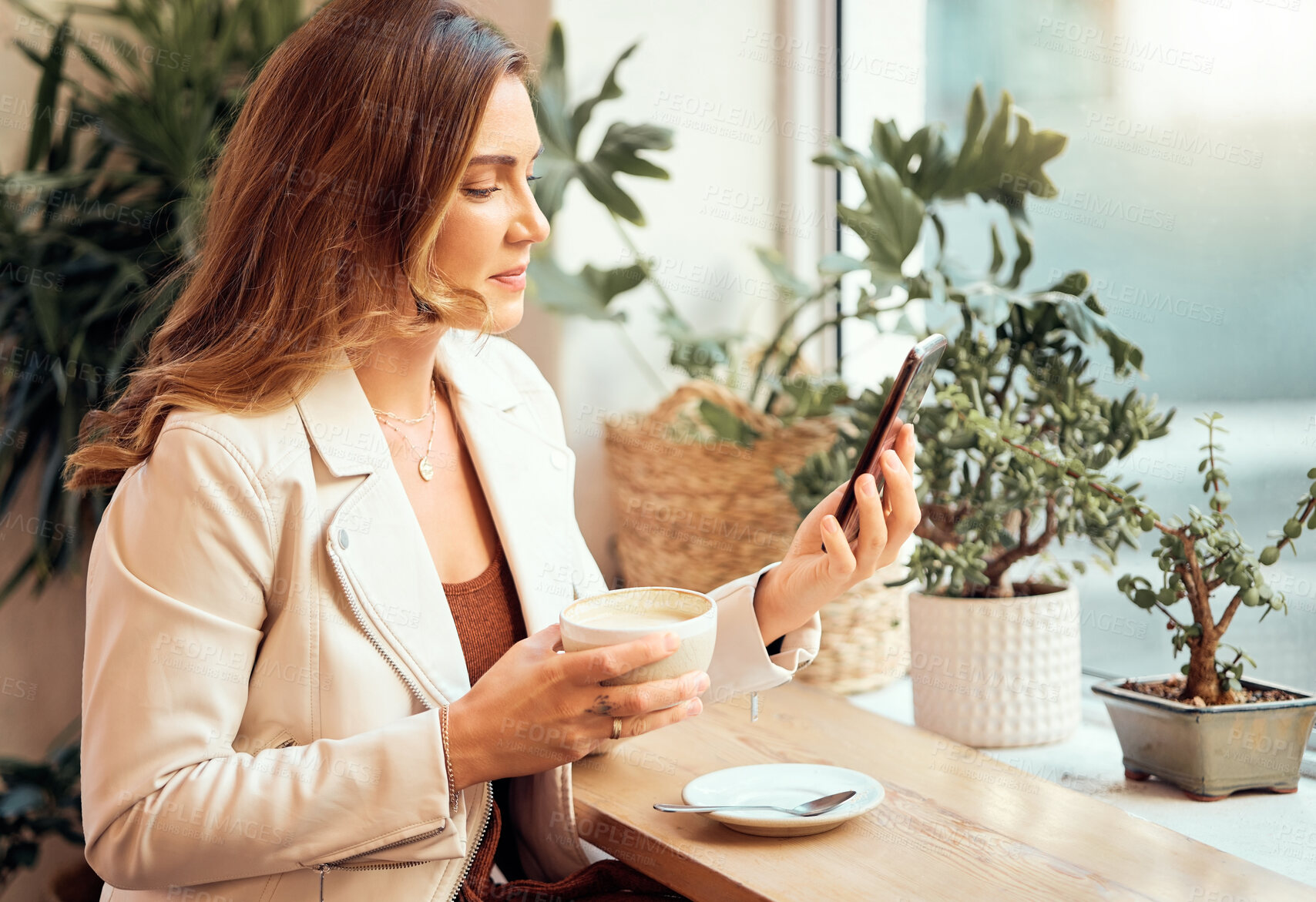 Buy stock photo Coffee shop, phone and communication with a woman customer drinking while typing a text message by a window. Internet cafe, mobile and social media with a female enjoying a drink in a restaurant