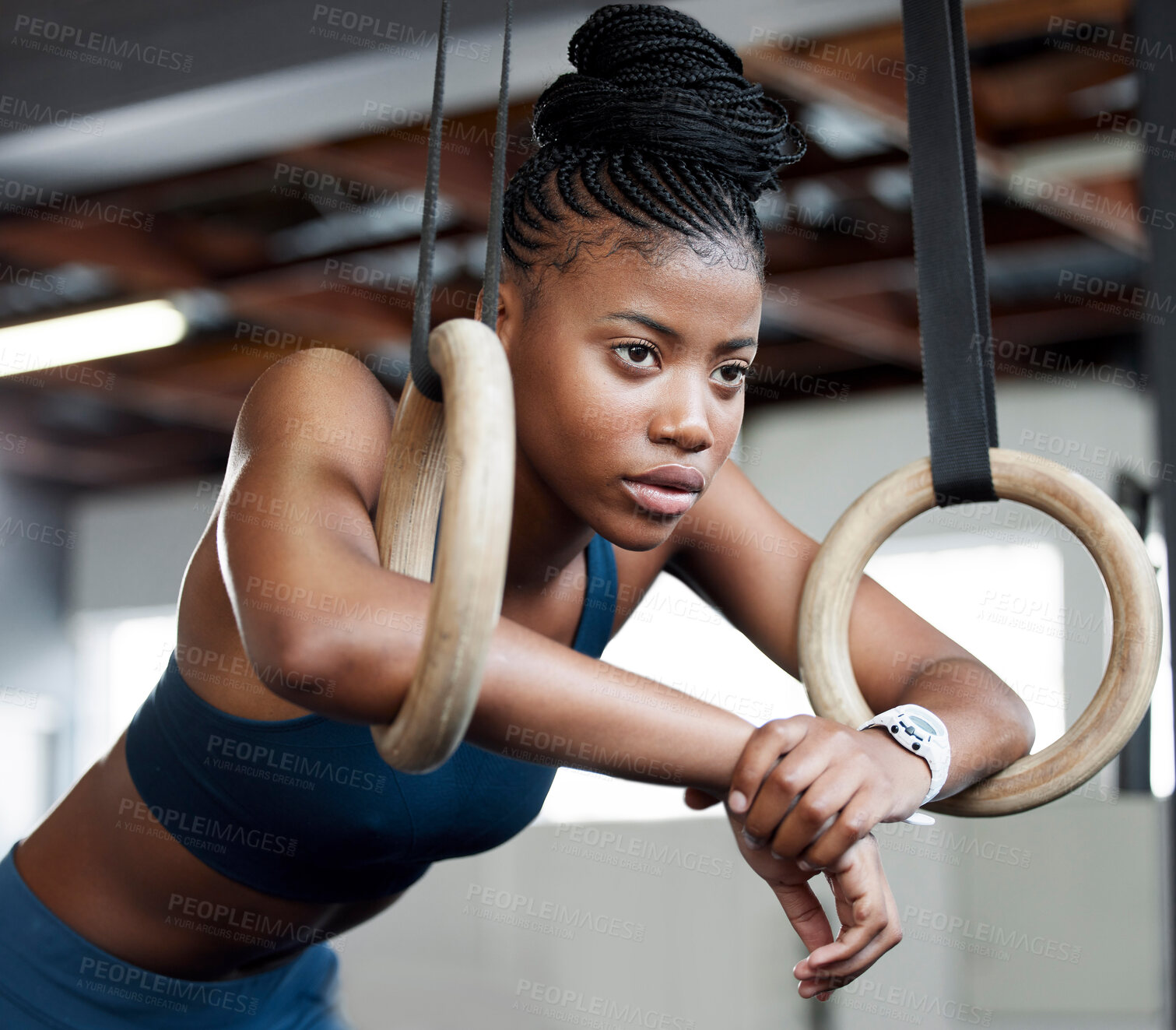 Buy stock photo Black woman, fitness and gymnastics with rings for training, muscle and arms at gym. African American female acrobat or gymnast face in strong focus for exercise, workout or practice at the gymnasium