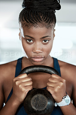 Buy stock photo Fitness, portrait or black woman in gym with a kettlebell for strength training, exercise or workout. Motivation, face or healthy strong athlete with focus or weight for muscle development or growth