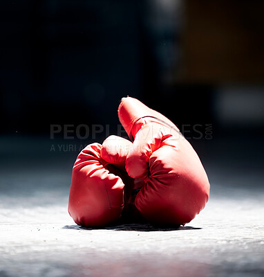 Buy stock photo Boxing gloves, floor and sports on a dark background in studio for health, competition or exercise. Fitness, leather and protective sportswear for a boxer or athlete in competitive fighting