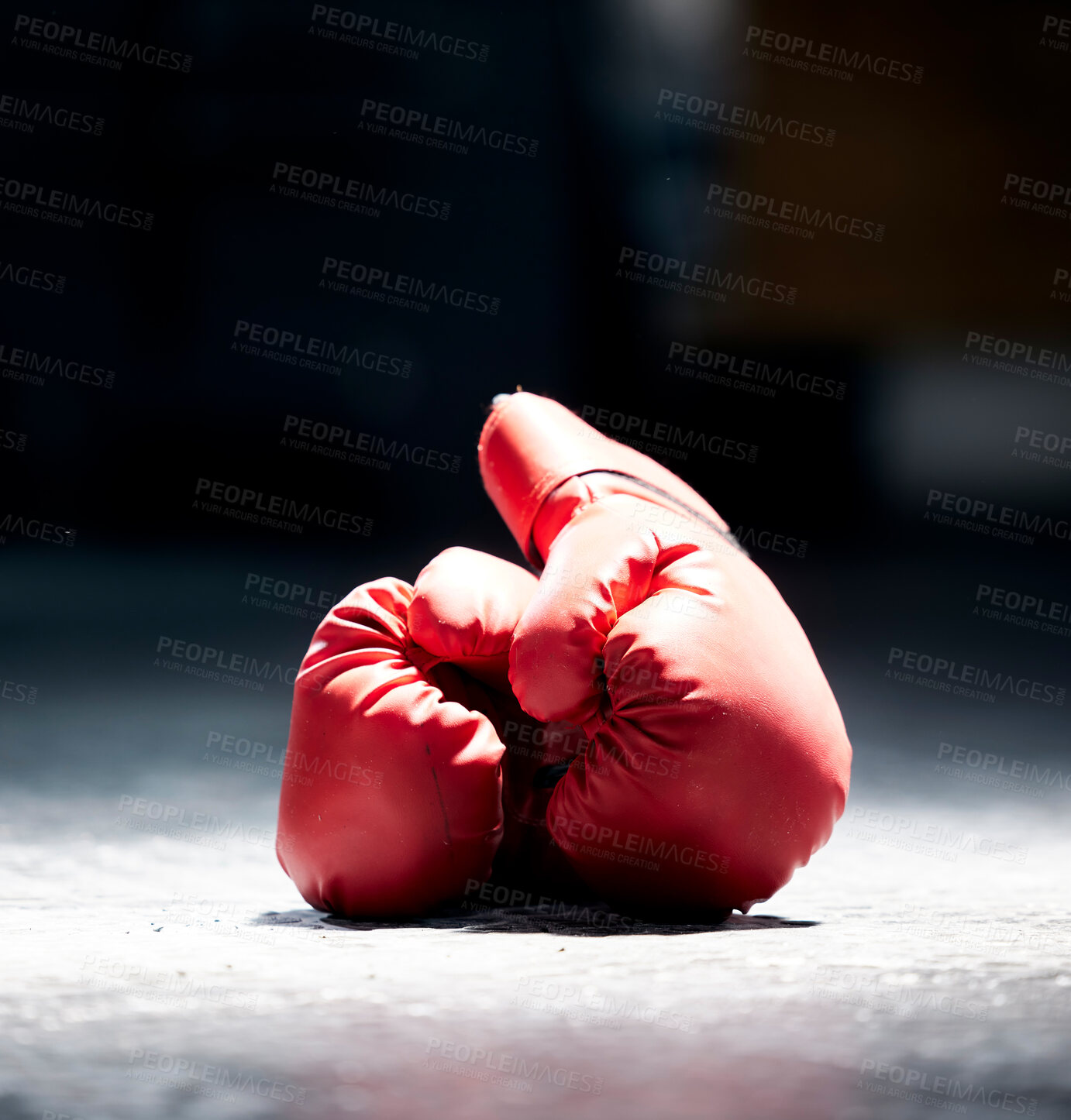 Buy stock photo Boxing gloves, floor and sports on a dark background in studio for health, competition or exercise. Fitness, leather and protective sportswear for a boxer or athlete in competitive fighting