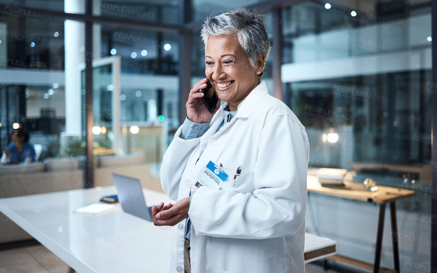 Buy stock photo Doctor, senior woman and phone call in hospital conversation, talking and networking. Smartphone, night and female medical physician in discussion, telehealth or consulting for support in clinic.