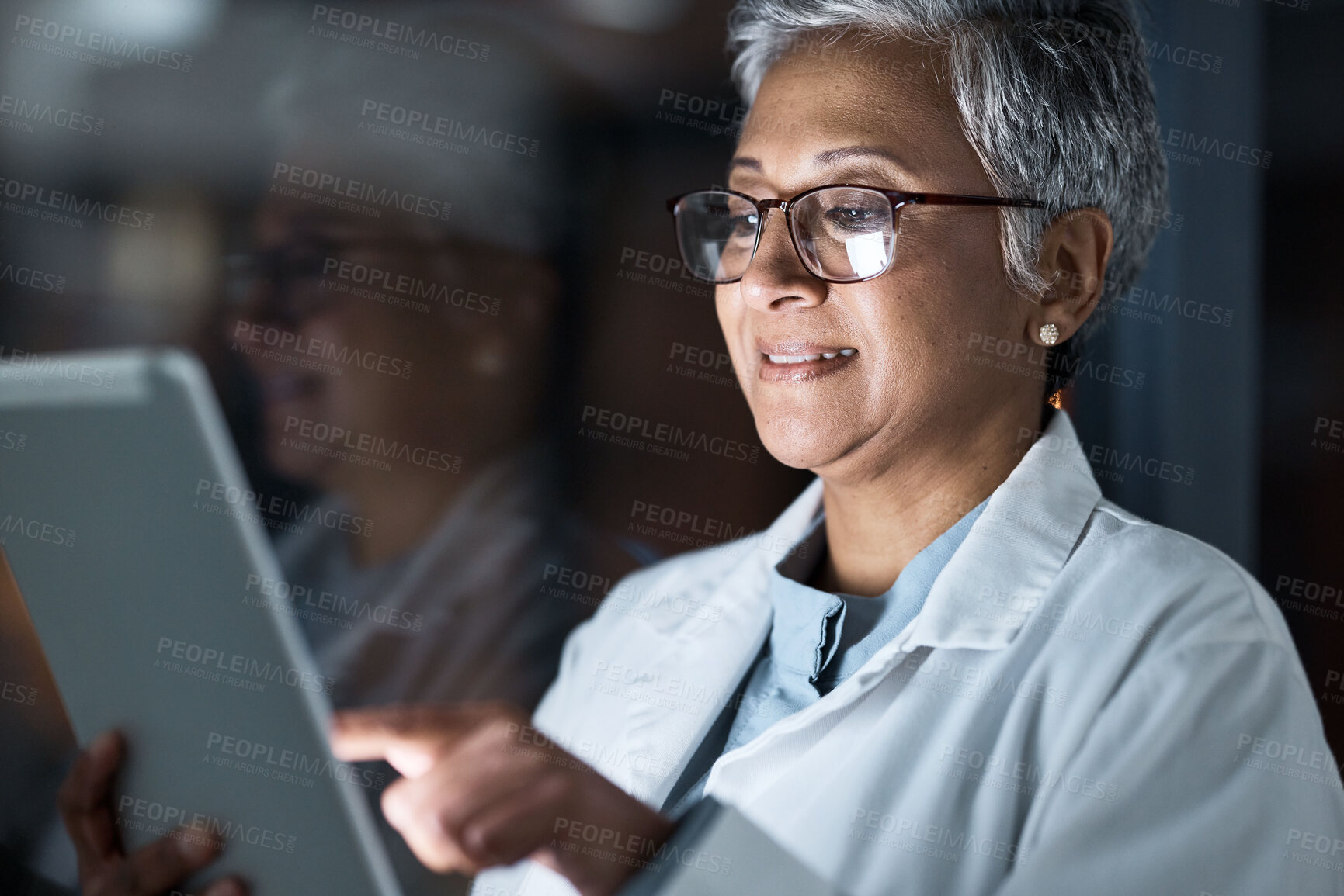 Buy stock photo Medical, research and night with doctor and tablet for planning, medicine and schedule. Technology, review and digital with senior woman reading report for healthcare, science and life insurance news