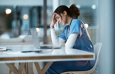 Buy stock photo Headache stress, nurse and black woman in hospital feeling pain, tired or sick on night shift. Healthcare, wellness or female medical physician with depression or burnout while working late on laptop