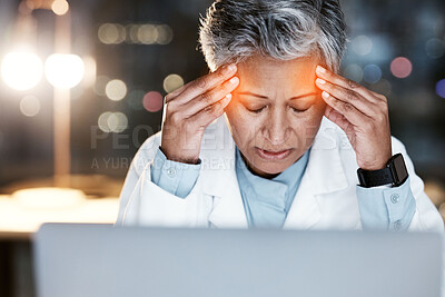 Buy stock photo Night, stress and headache with doctor at laptop for medical, stress and deadline review. Burnout, accountability and mental health with senior woman for healthcare, medicine and science research