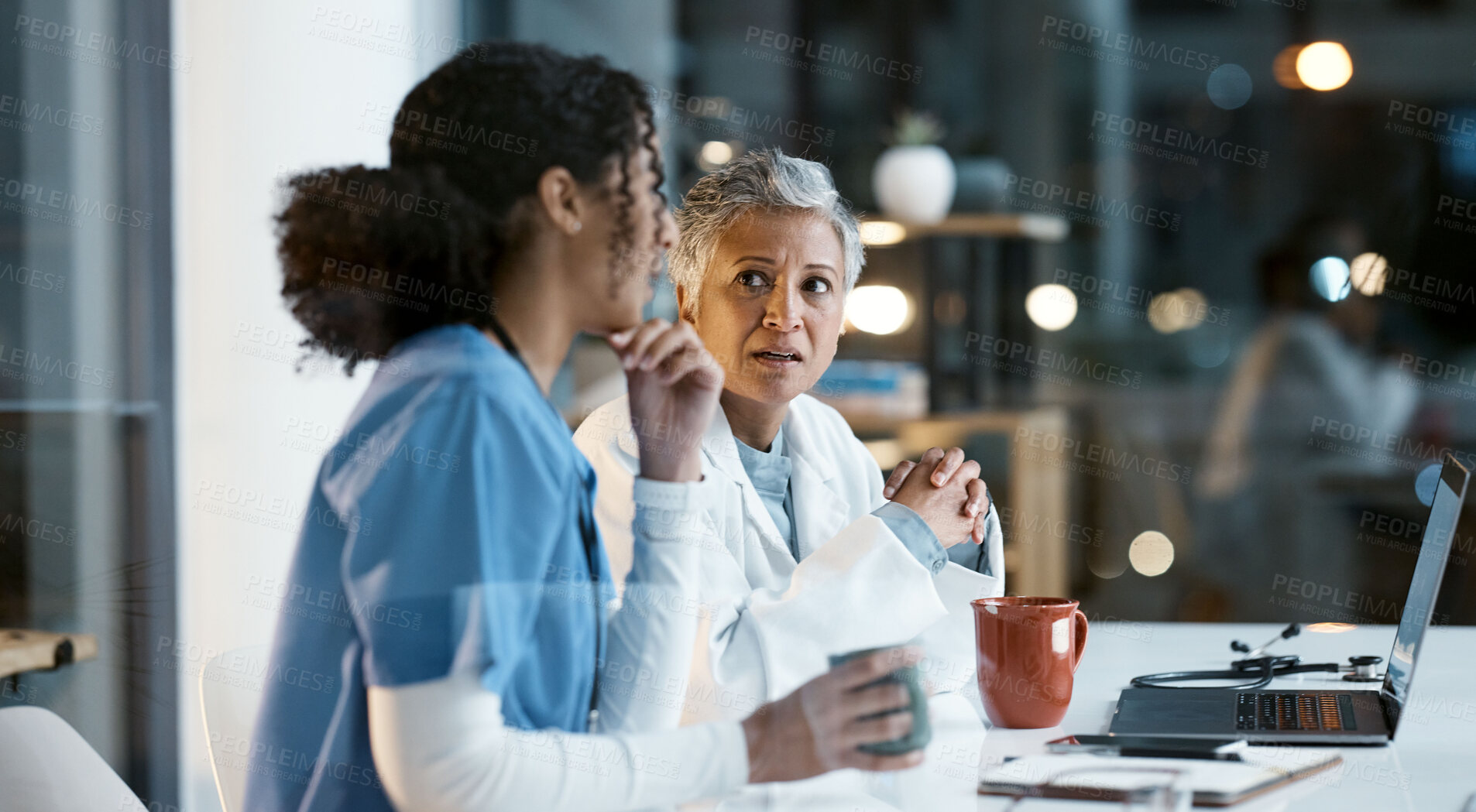 Buy stock photo Doctor, team and laptop in discussion at night for healthcare strategy or planning at hospital. Women medical professional in collaboration working late together for teamwork, conversation or ideas