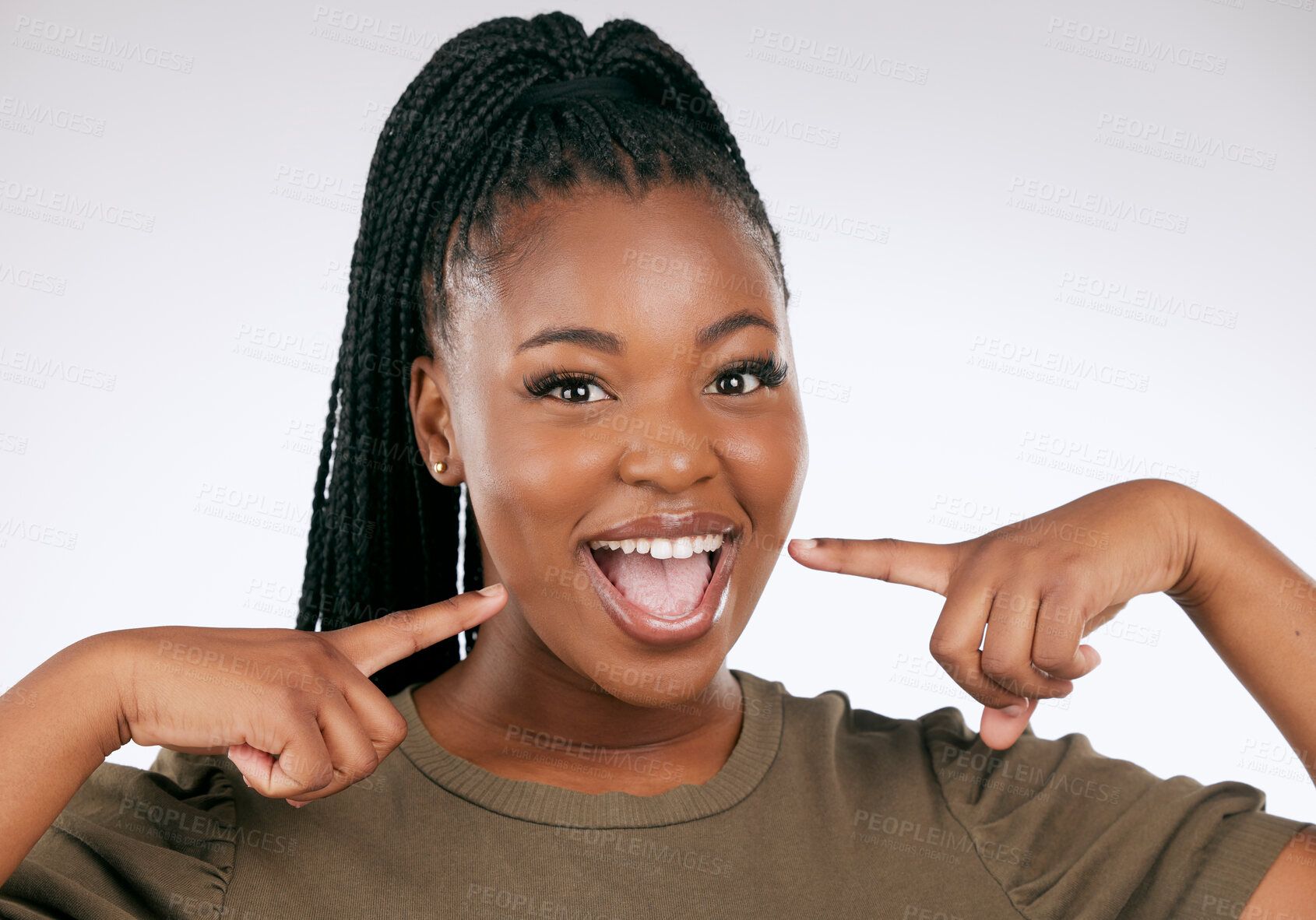 Buy stock photo Portrait, dental and a black woman pointing to her mouth in studio on a gray background for oral hygiene. Face, teeth and an attractive young female inside to point at her teeth for whitening