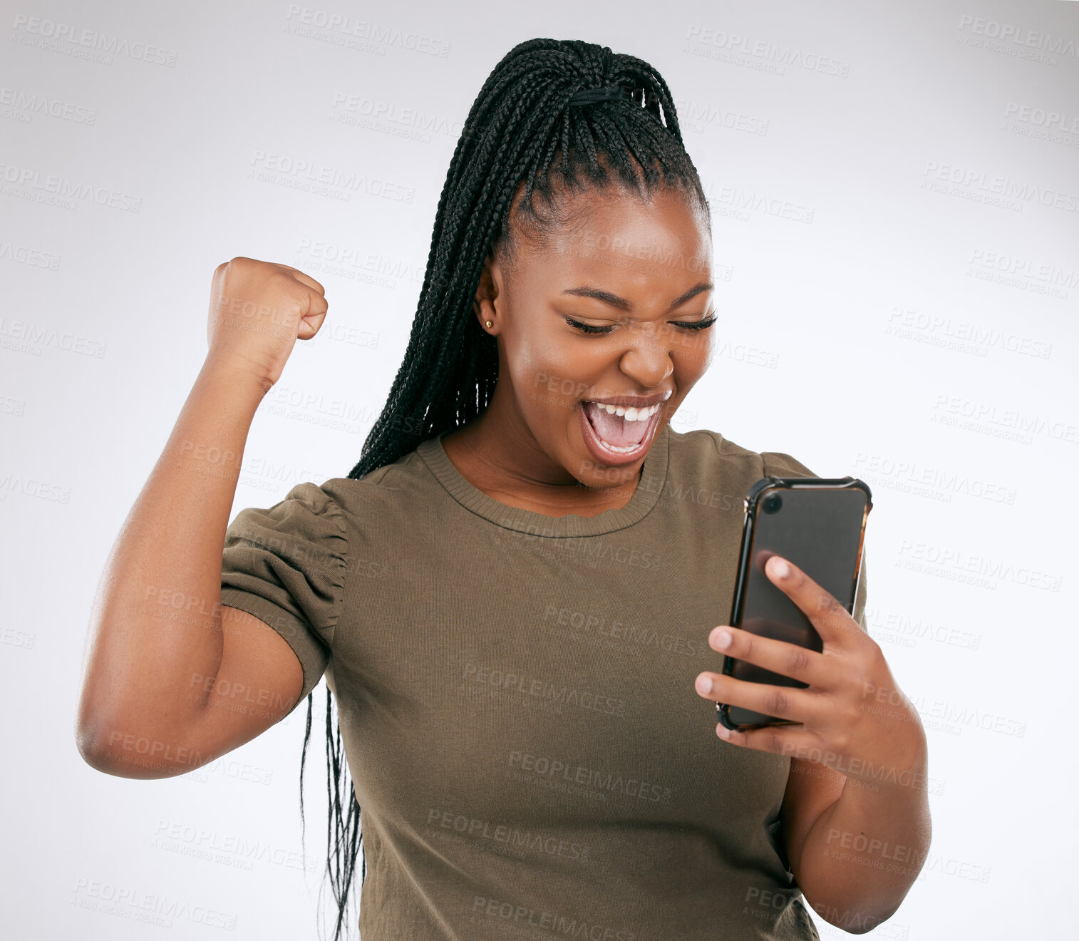 Buy stock photo Black woman, phone and victory for winning, discount or sale against a grey studio background. Happy African American female winner excited for achievement, good news or celebrating win on smartphone
