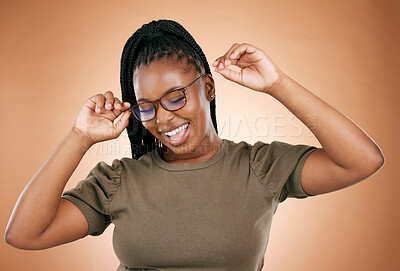 Buy stock photo Happy, fashion or glasses with a carefree black woman in studio on a brown background for vision. Smile, style or eyewear and an attractive young female with a cheerful expression in frame spectacles