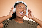 Headphones, singing and portrait of woman isolated on studio background in mental health, energy and radio music. Singer, voice and gen z black people listening to sound, audio technology on mockup